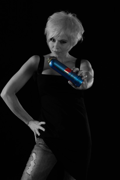Blond female model in black & white holding an hairspray bottle in colour - Photography 301 - Photographed by Peter Gatt - School of Photography